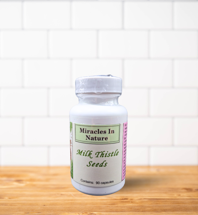 A bottle of milk thistle seeds is sitting on a wooden table.