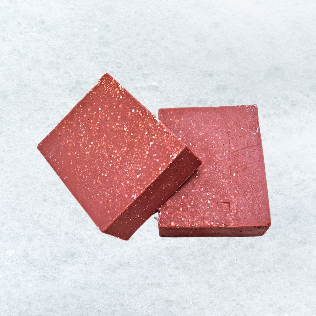 Two red squares are sitting on a wooden table