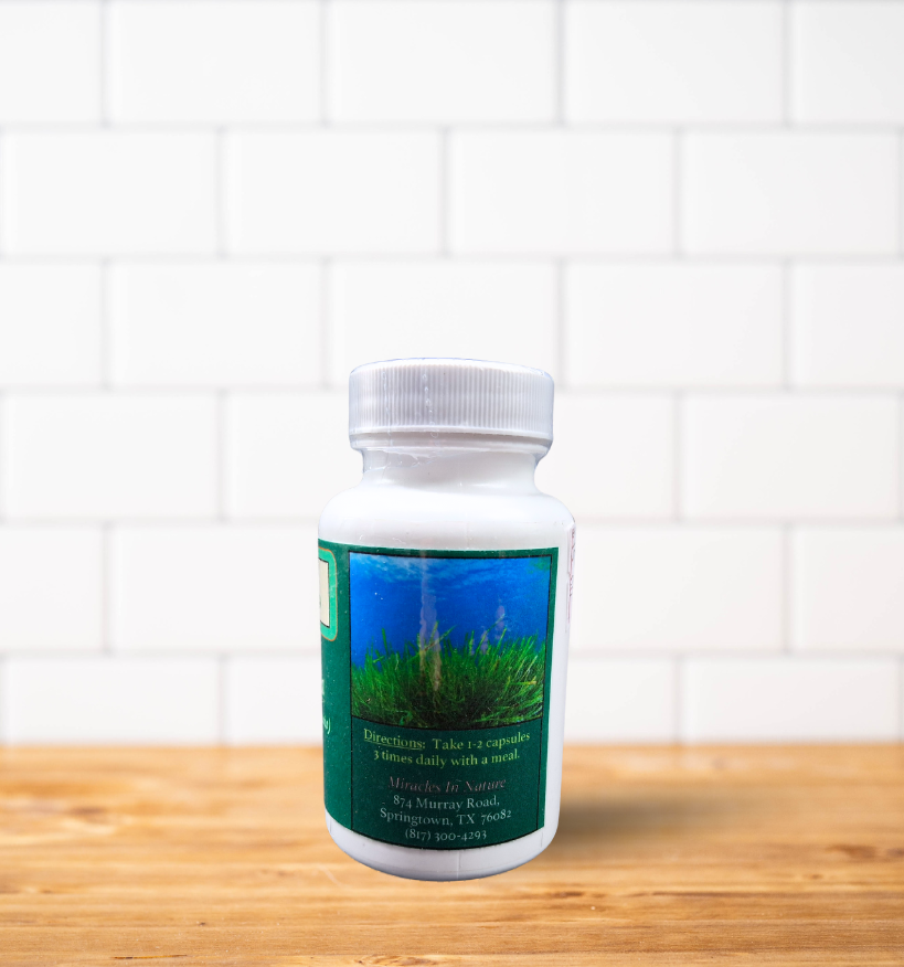 A bottle of pills is sitting on a wooden table.