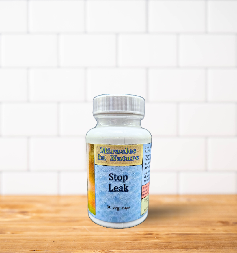 A bottle of stop leak is sitting on a wooden table.