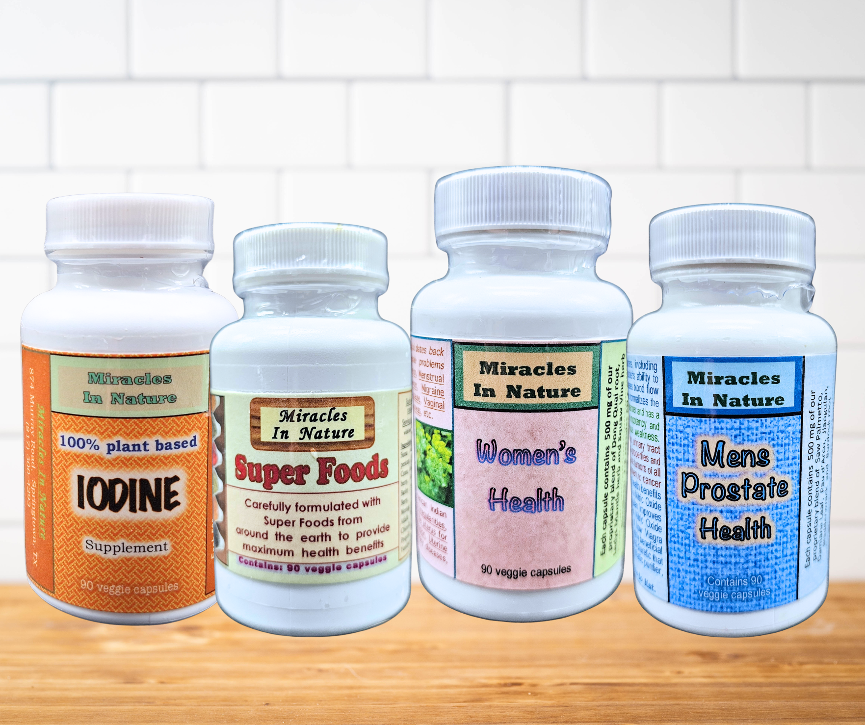 Four bottles of supplements are sitting on a wooden table.