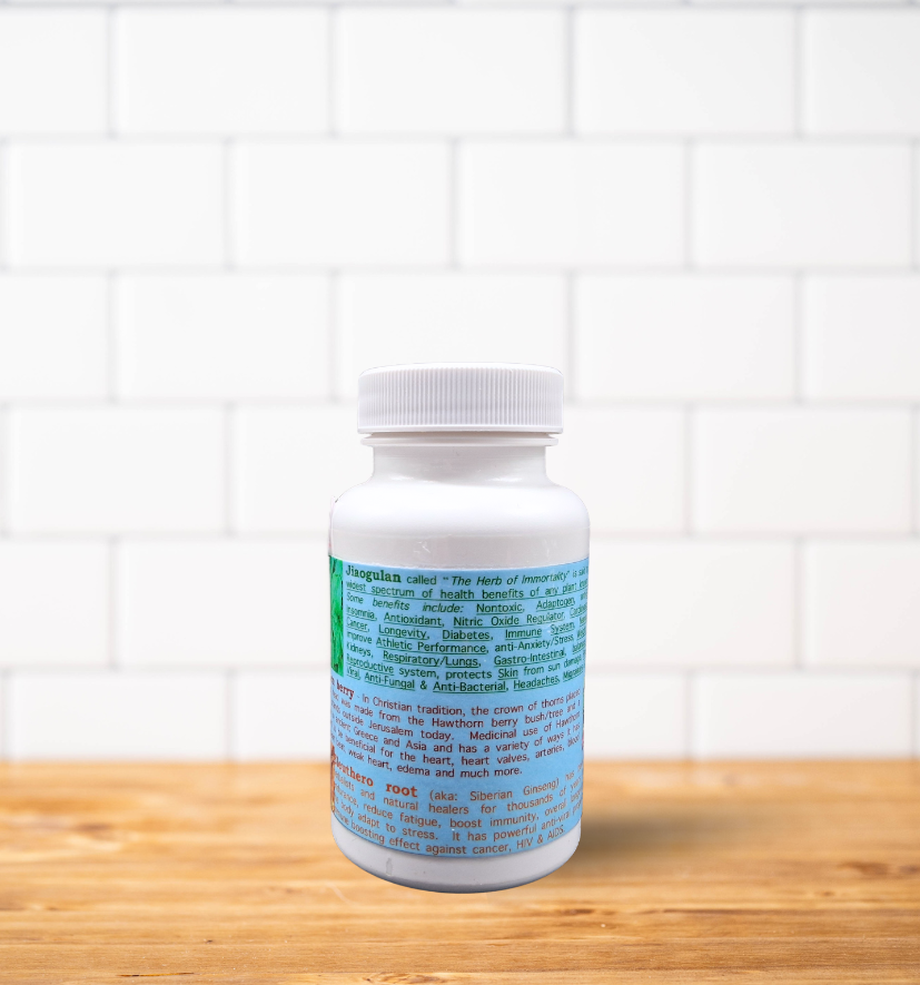 A bottle of pills is sitting on a wooden table in front of a white brick wall.