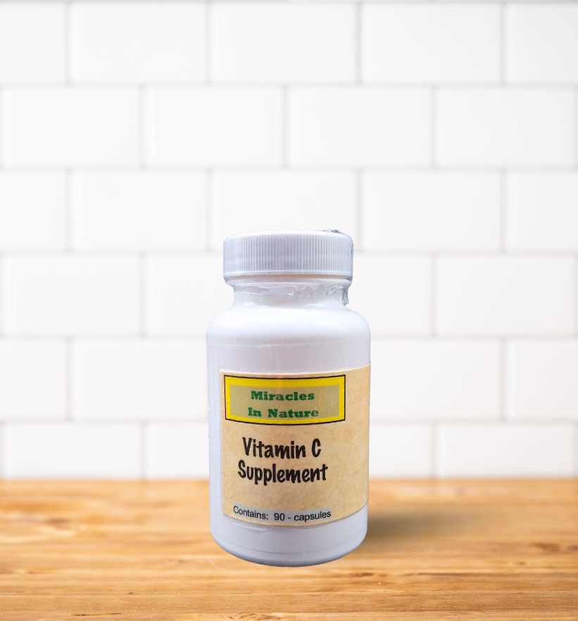 A bottle of vitamin c supplement is sitting on a wooden table
