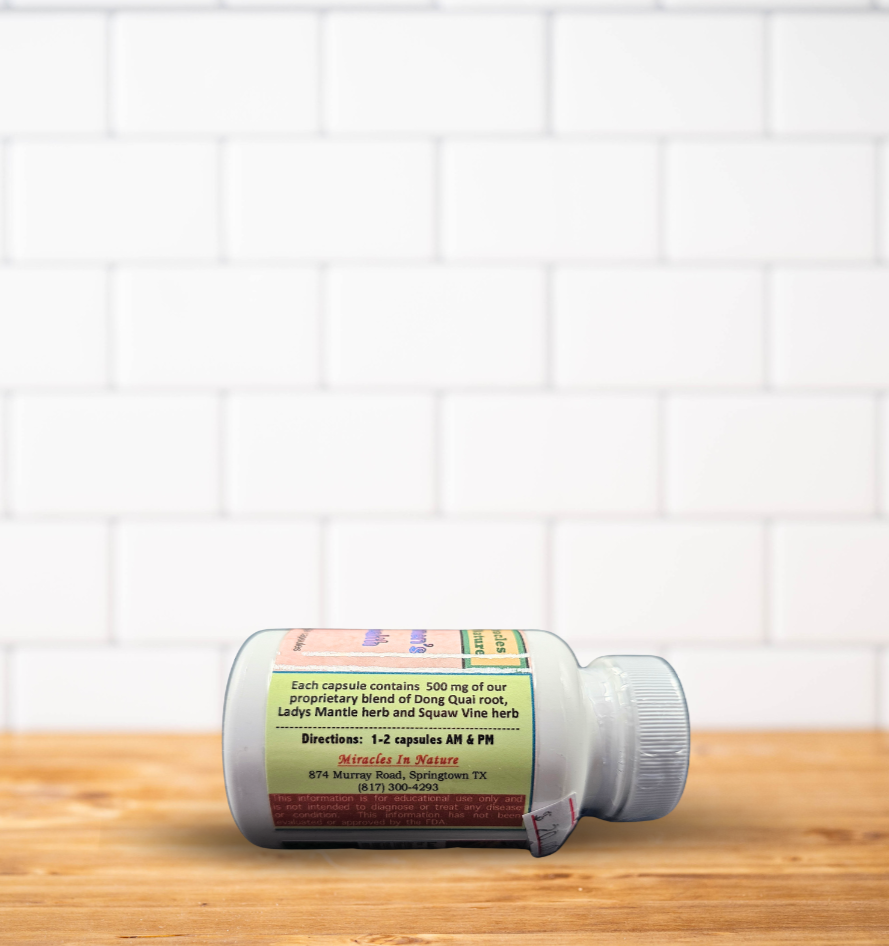 A bottle of pills is sitting on a wooden table in front of a white brick wall.