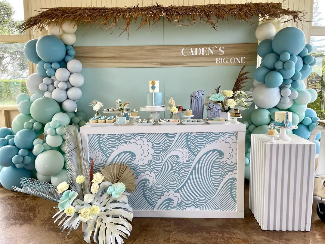 A table decorated with balloons and flowers for a baby shower.
