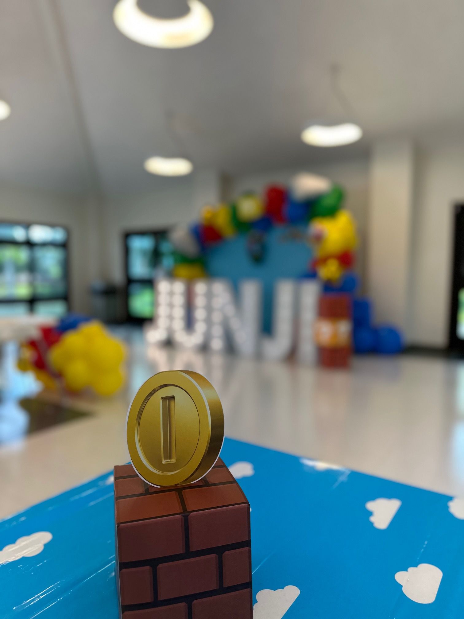 A gold coin is sitting on a brick in front of a sign that says junji