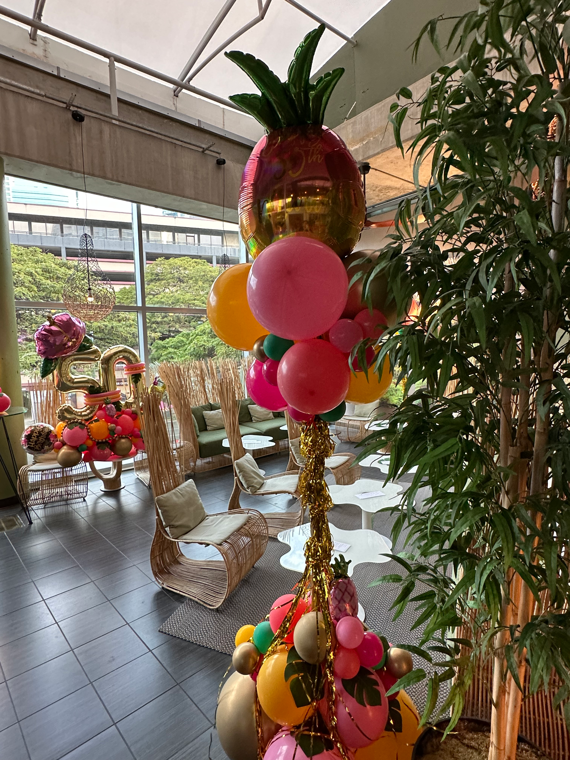 A bunch of balloons are sitting on top of each other in a room.