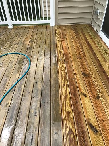 A wooden deck, half cleaned, showing the contrast between weathered wood and freshly cleaned, stained wood.