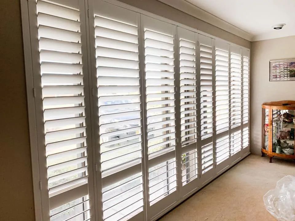 Bright Living Room With Large White Plantation Shutters — Paint Place Cowra in Cowra, NSW