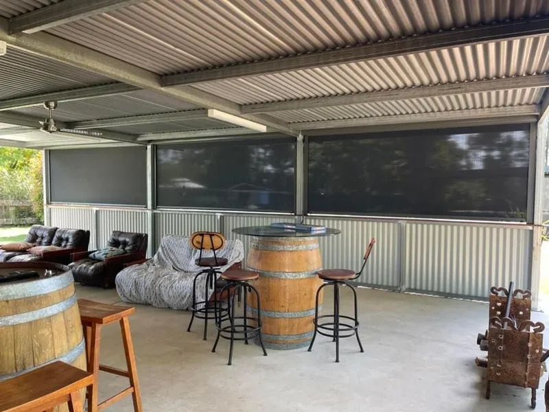 Covered Patio With Bar Stools, Barrel Table, and Outdoor Seating — Paint Place Cowra in Cowra, NSW
