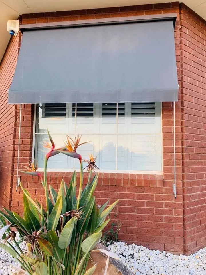 Brick House Window With Grey Awning — Paint Place Cowra in Cowra, NSW