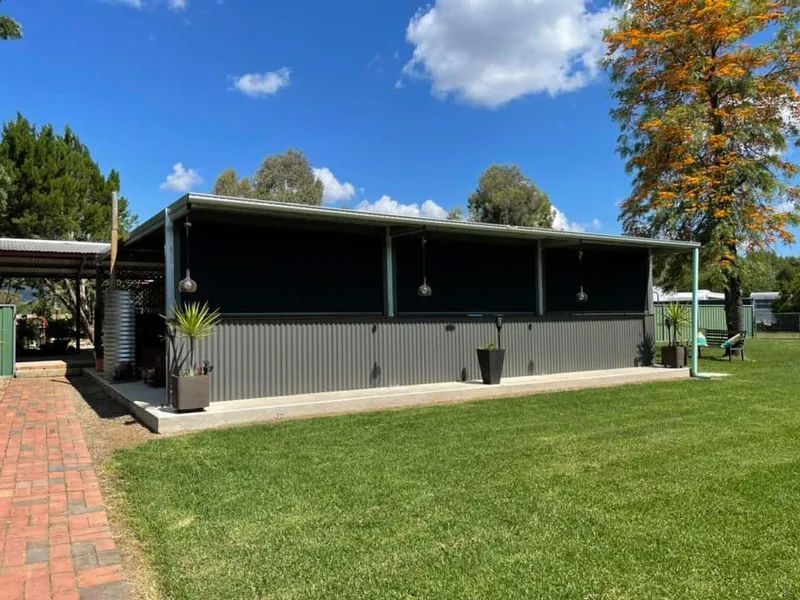 Long, Dark Grey Building Beside a Brick Path and Green Lawn — Paint Place Cowra in Cowra, NSW