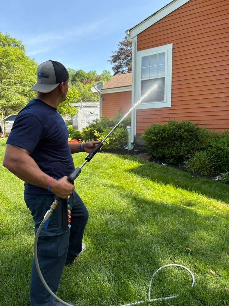 Patio cleaning service removing dirt and stains from an outdoor stone patio in Peekskill, NY.