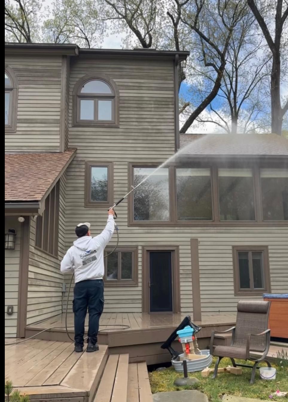 Professional deck cleaning service restoring a wooden deck with power washing in Peekskill, NY.