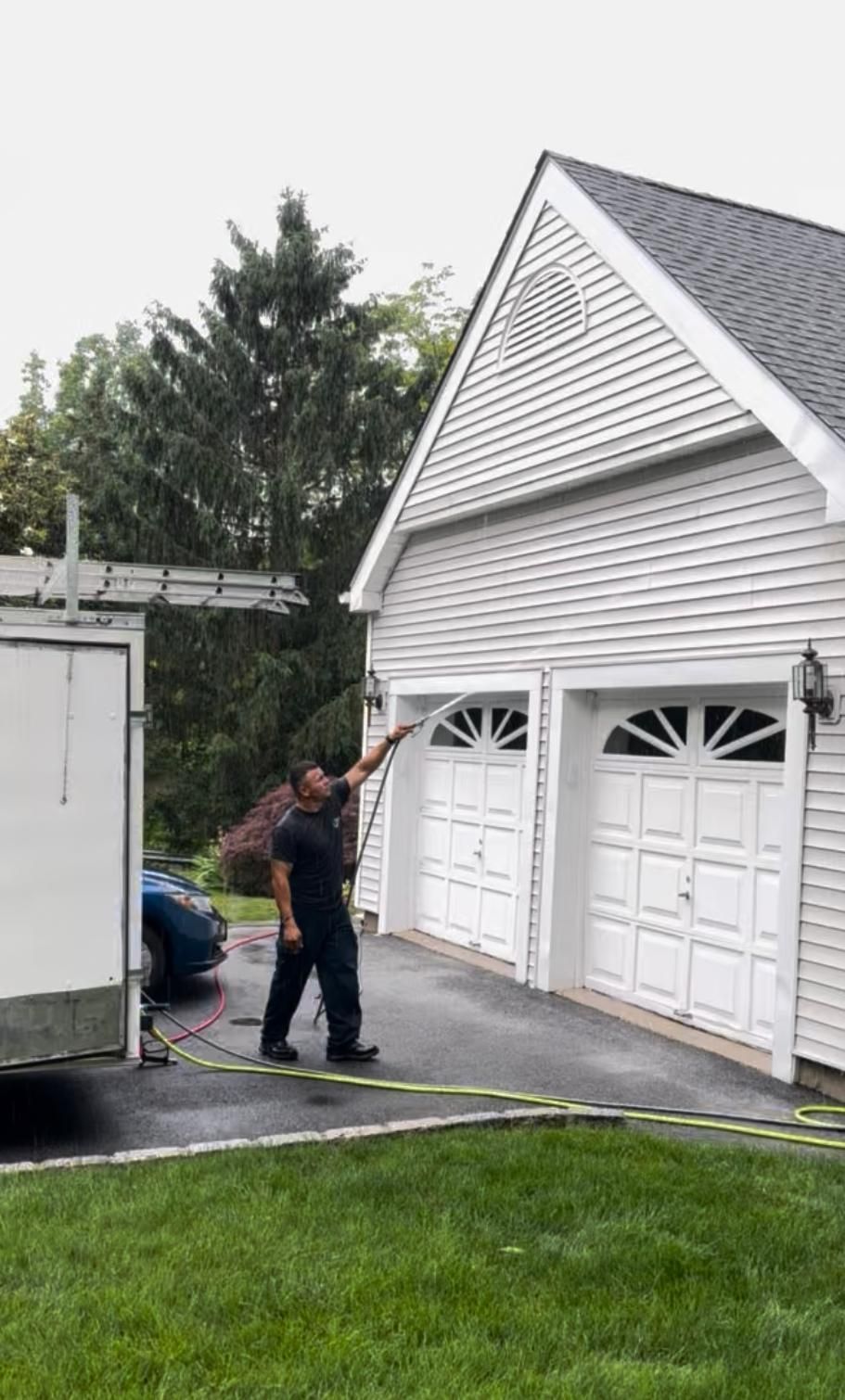 Commercial power washing technician cleaning a business property in Peekskill, NY with professional pressure washing equipment