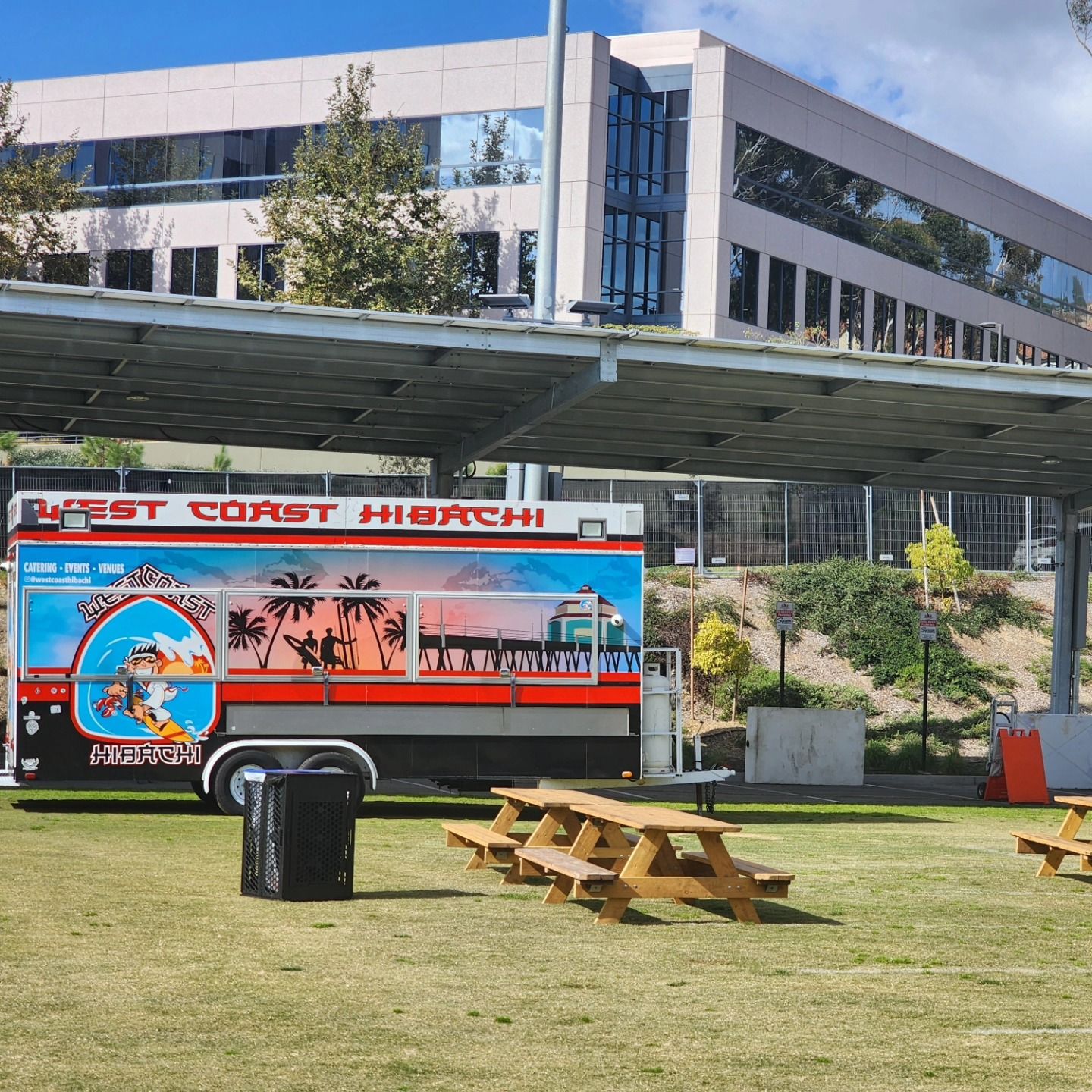 A first coast hibachi food truck is parked in a grassy area