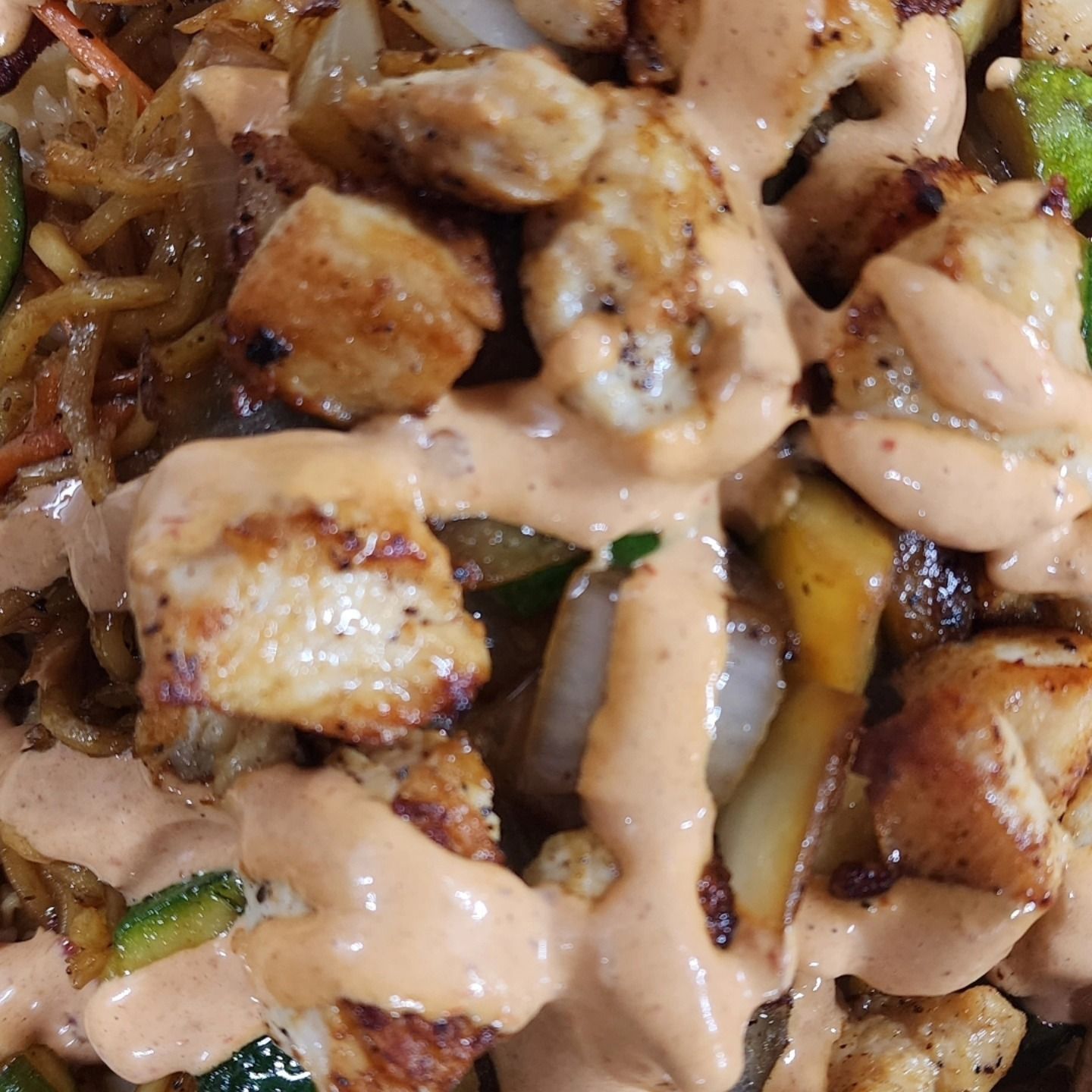 A close up of a plate of food with sauce on it.