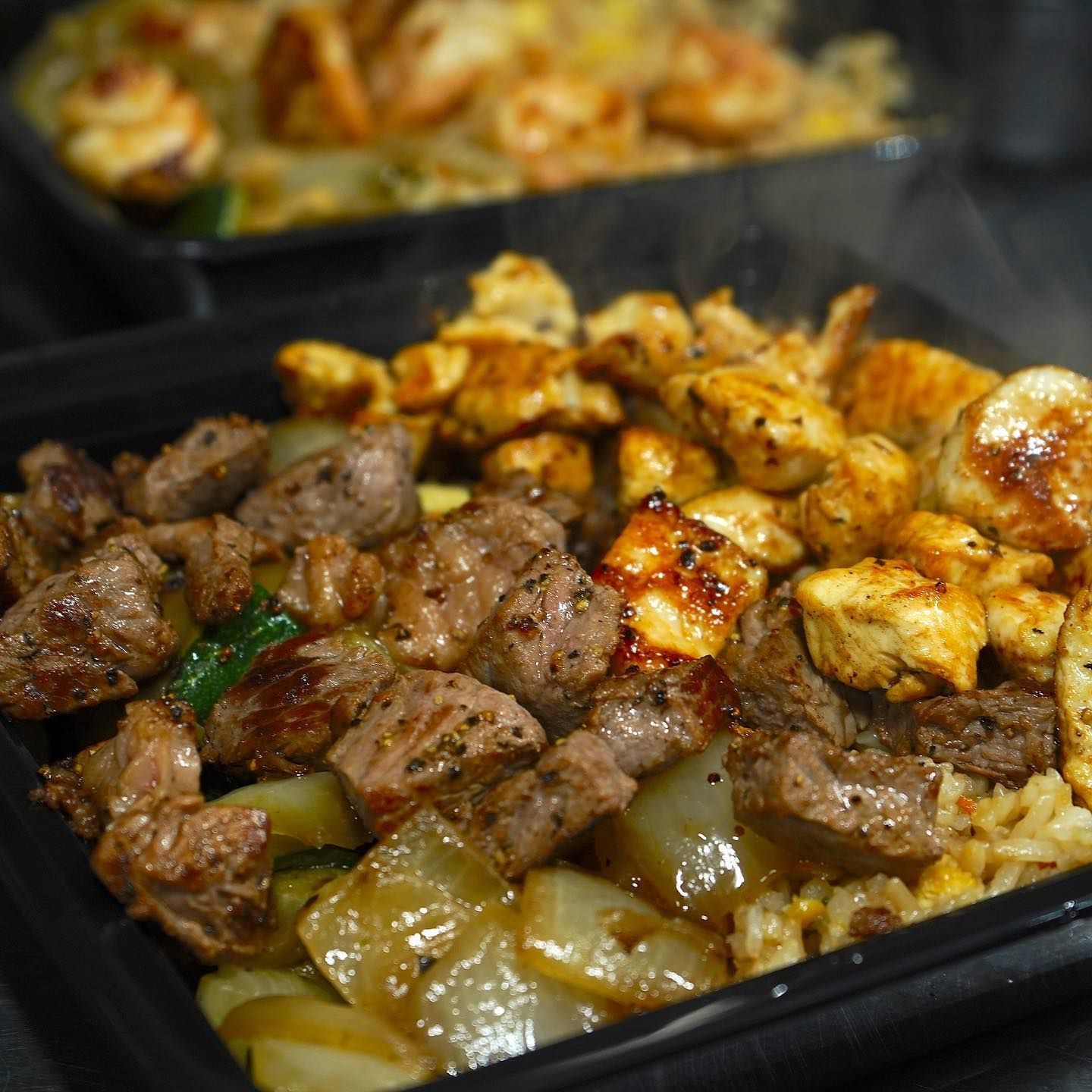 A close up of a tray of meat and chicken