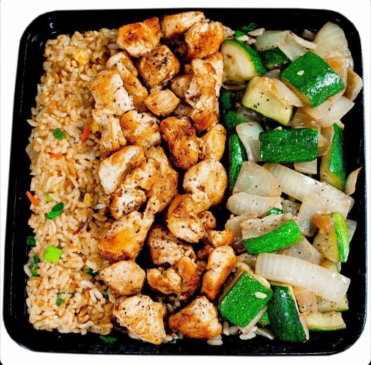 A plate of food with rice chicken and vegetables