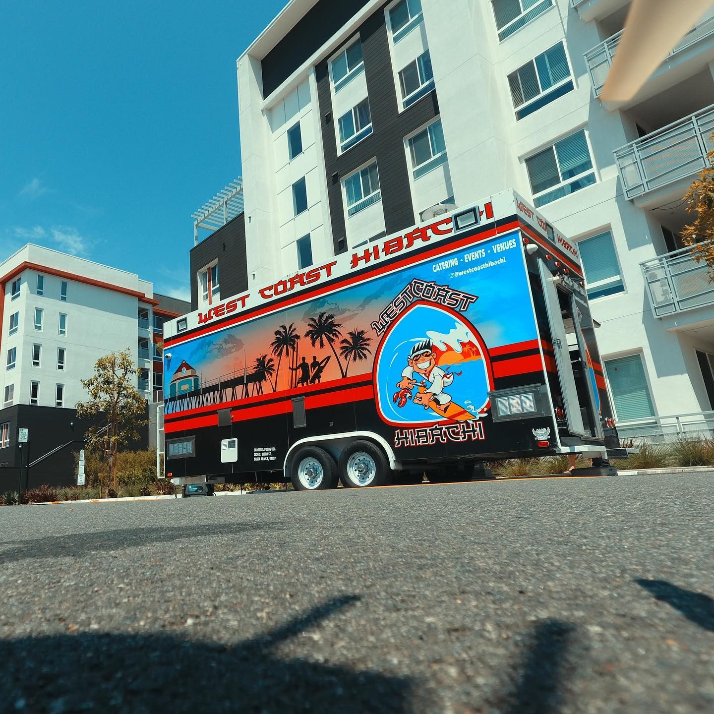 A large building with a trailer parked in front of it that says east coast heroes