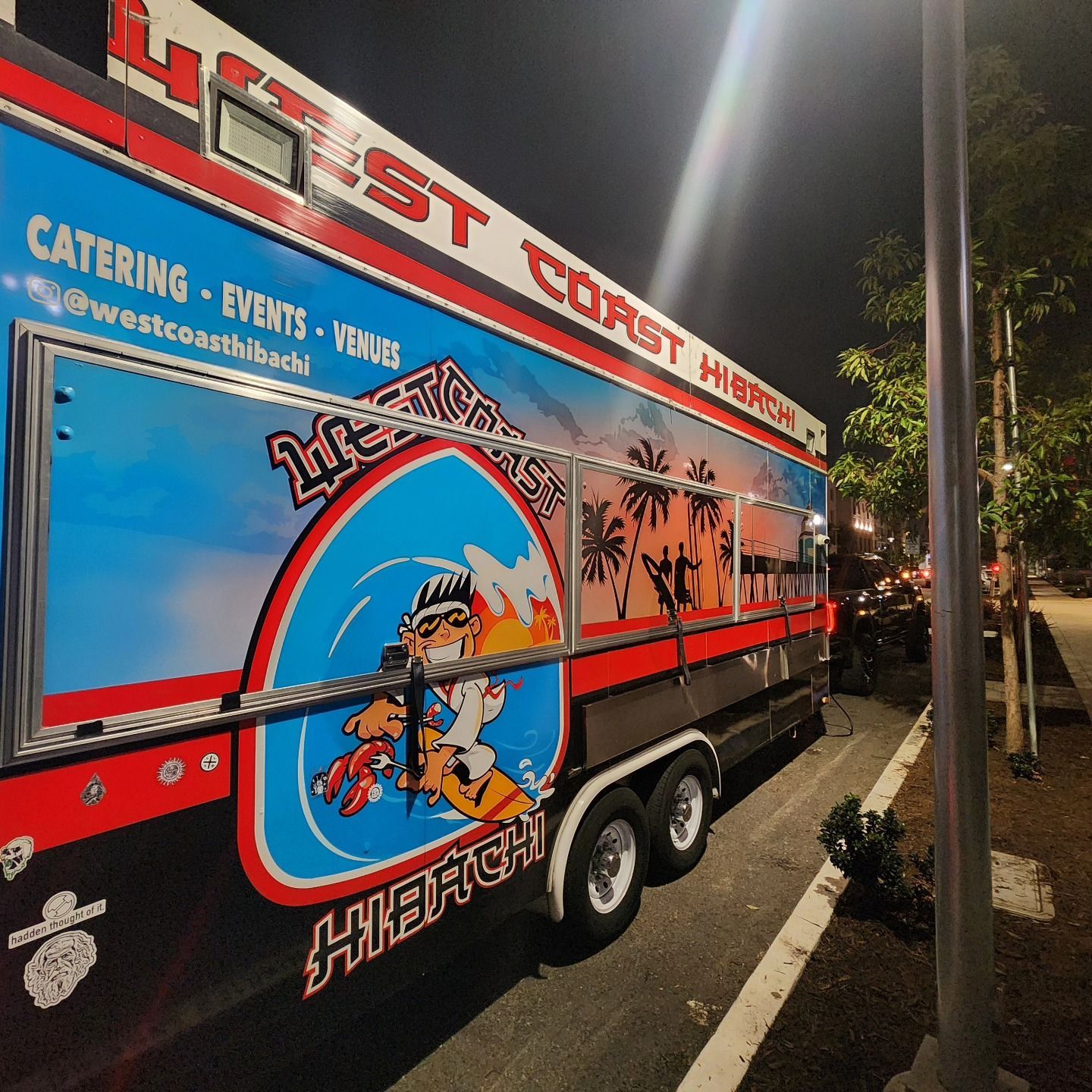 A west coast food truck is parked on the side of the road