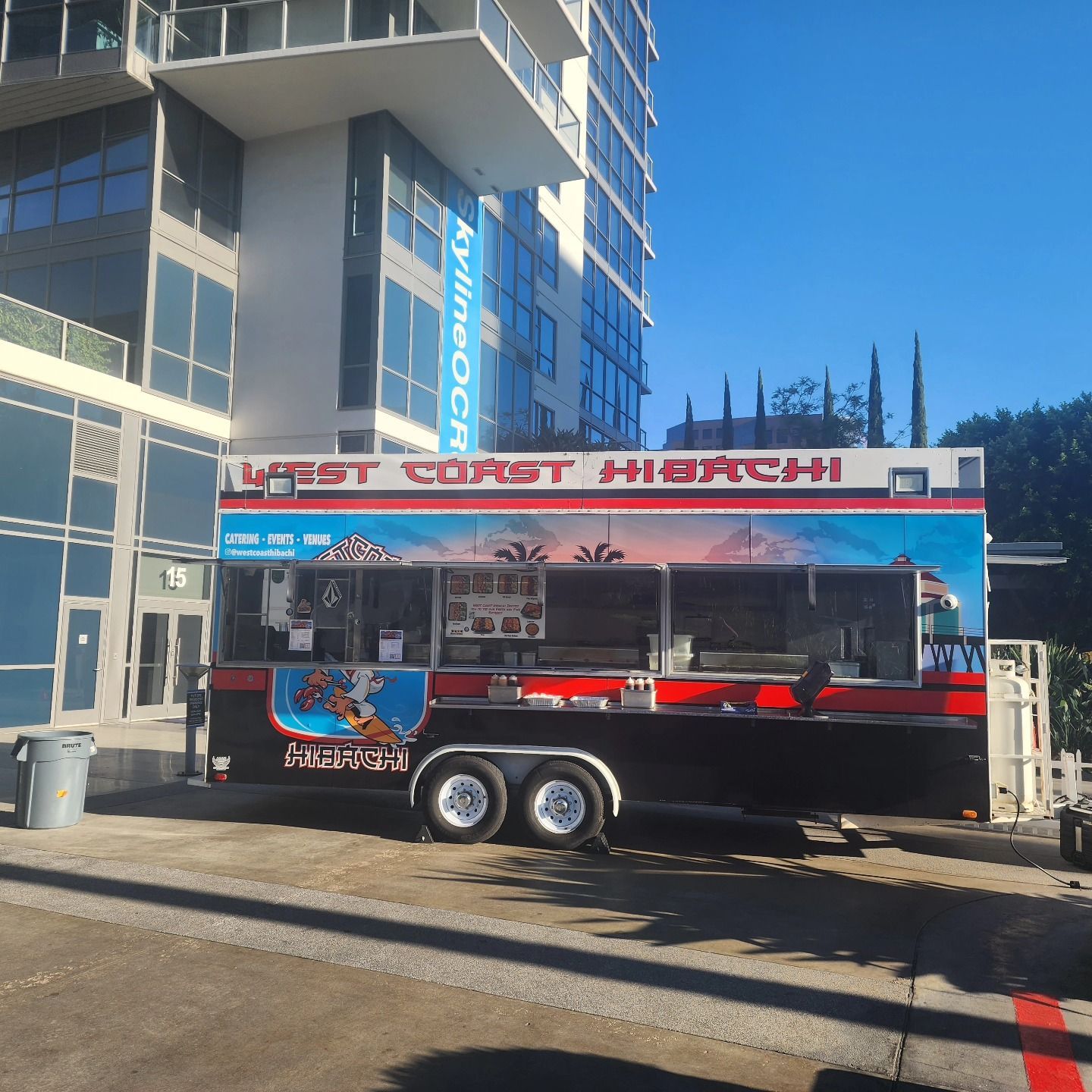 A food truck that says west corset hibachi is parked in front of a building