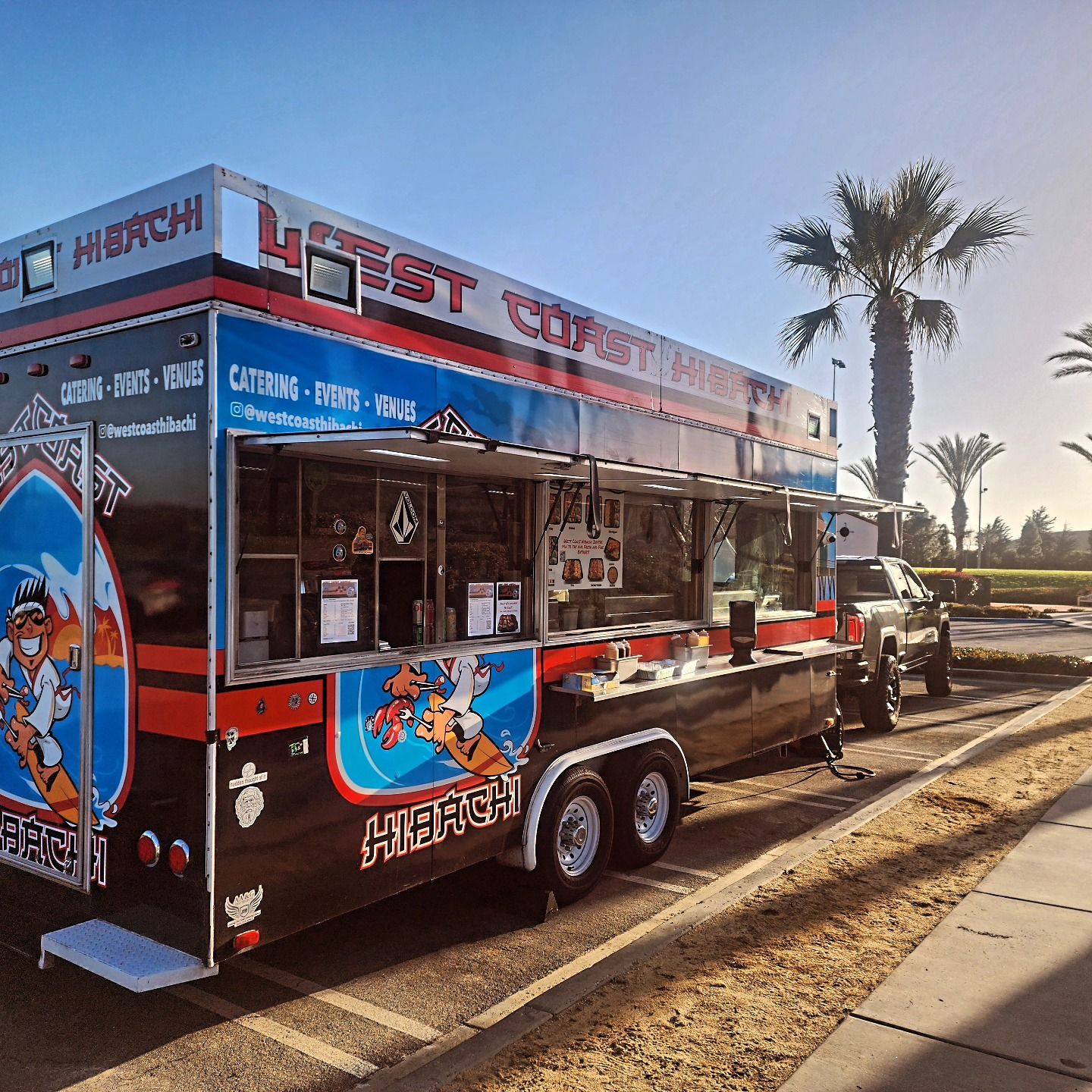 A food truck is parked on the side of the road
