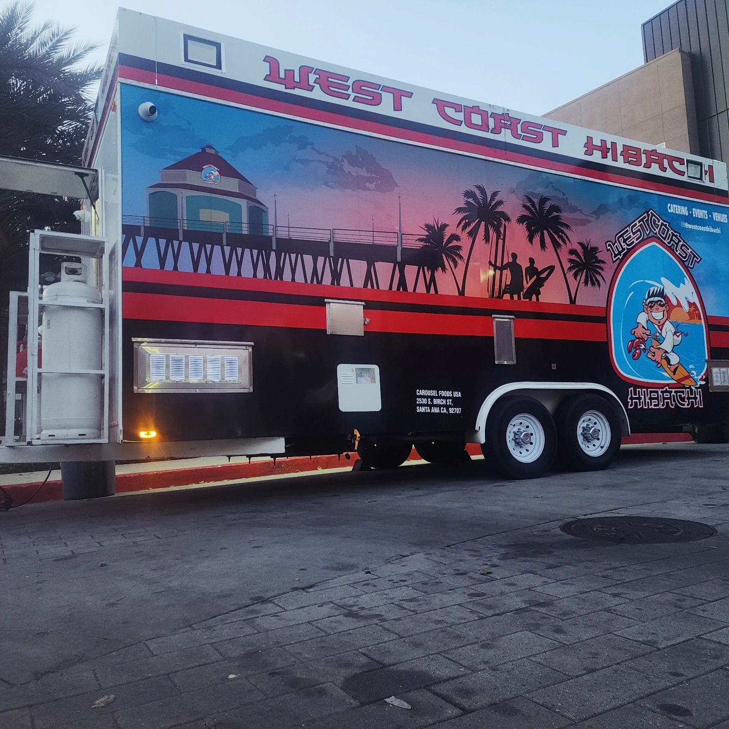 A west coast hi-way truck is parked on the side of the road