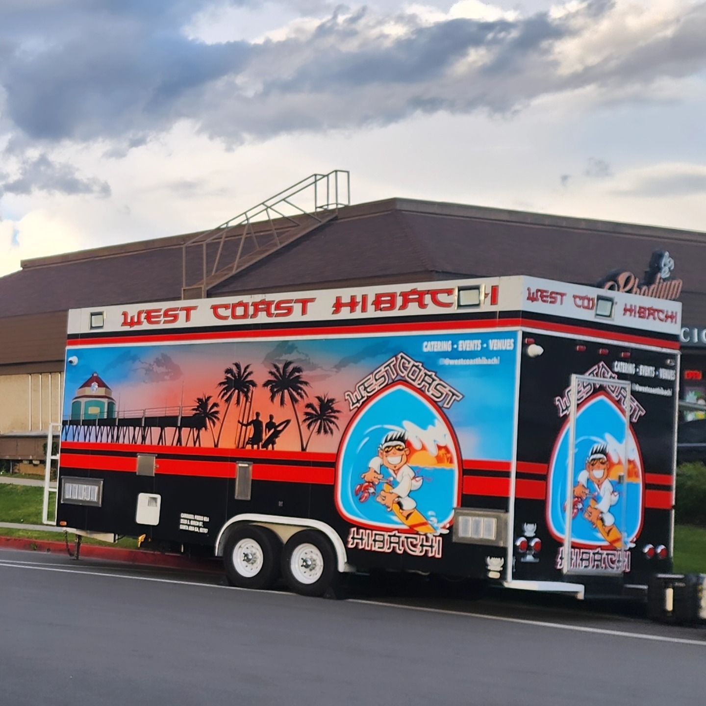 A west coast hibachi trailer is parked in front of a building