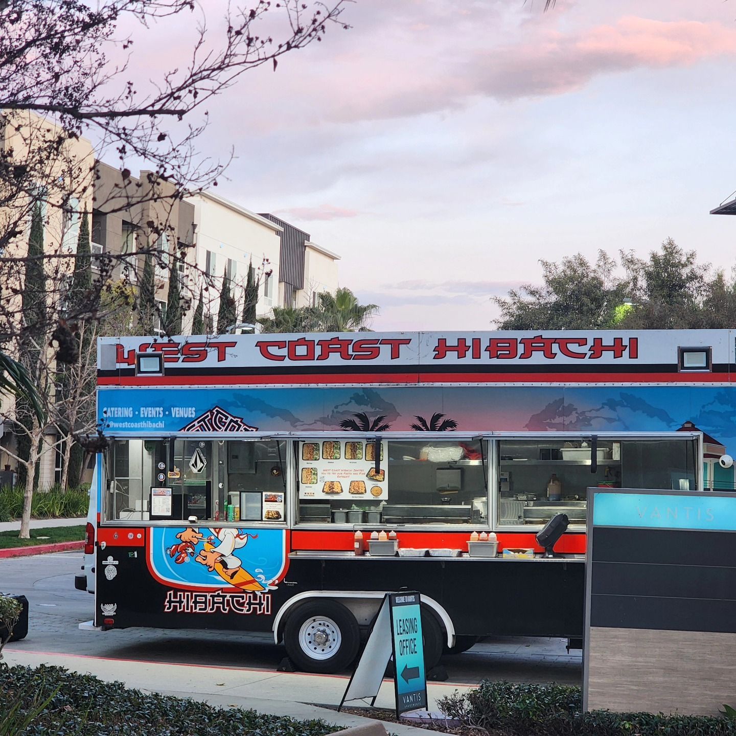A west coast hibachi food truck is parked on the side of the road