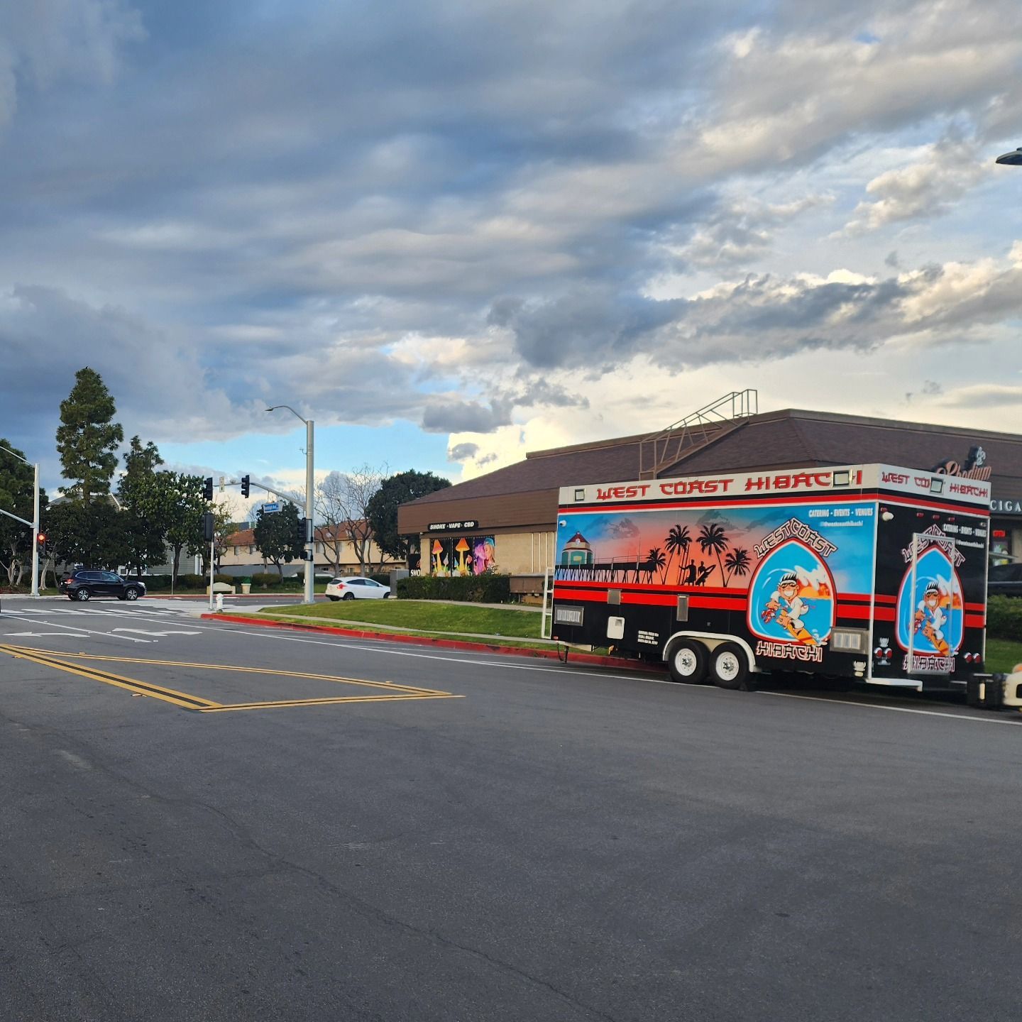 A food truck is parked on the side of the road