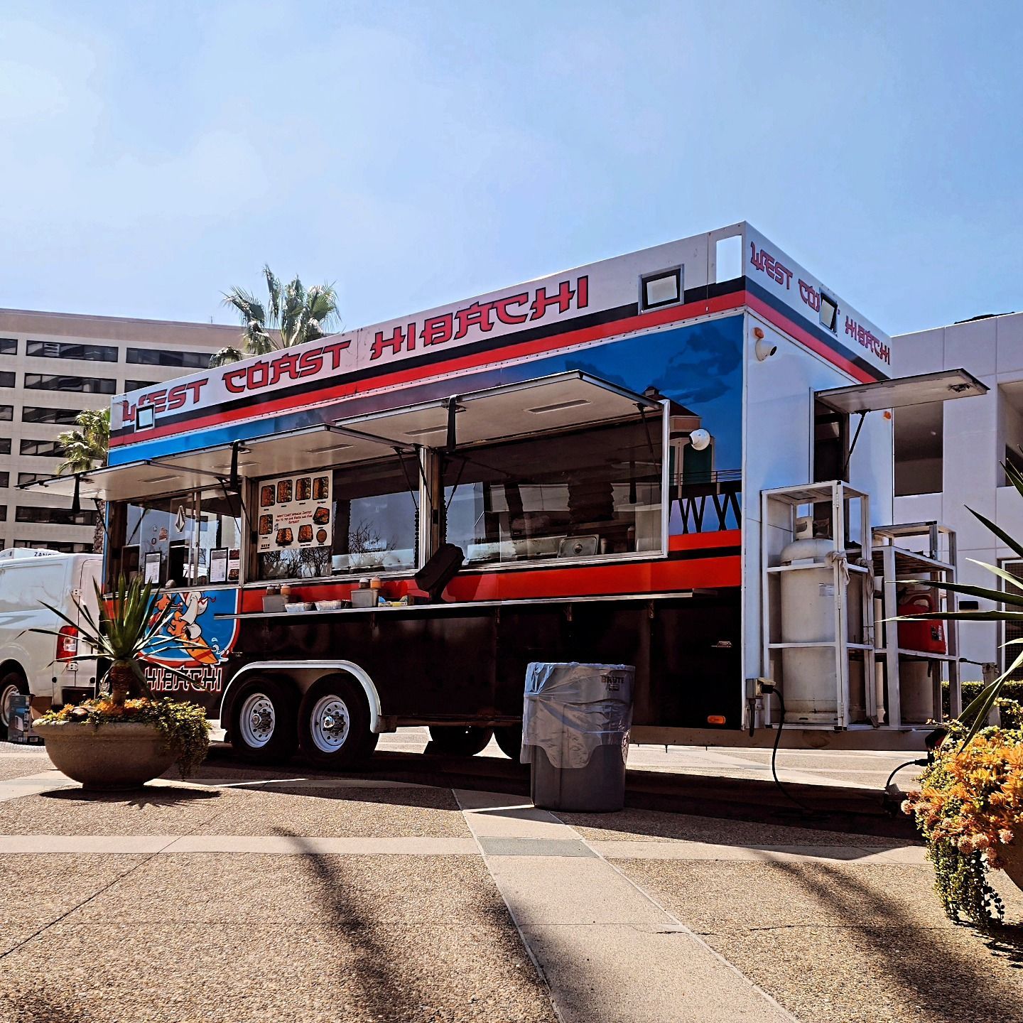 A food truck is parked on the side of the road