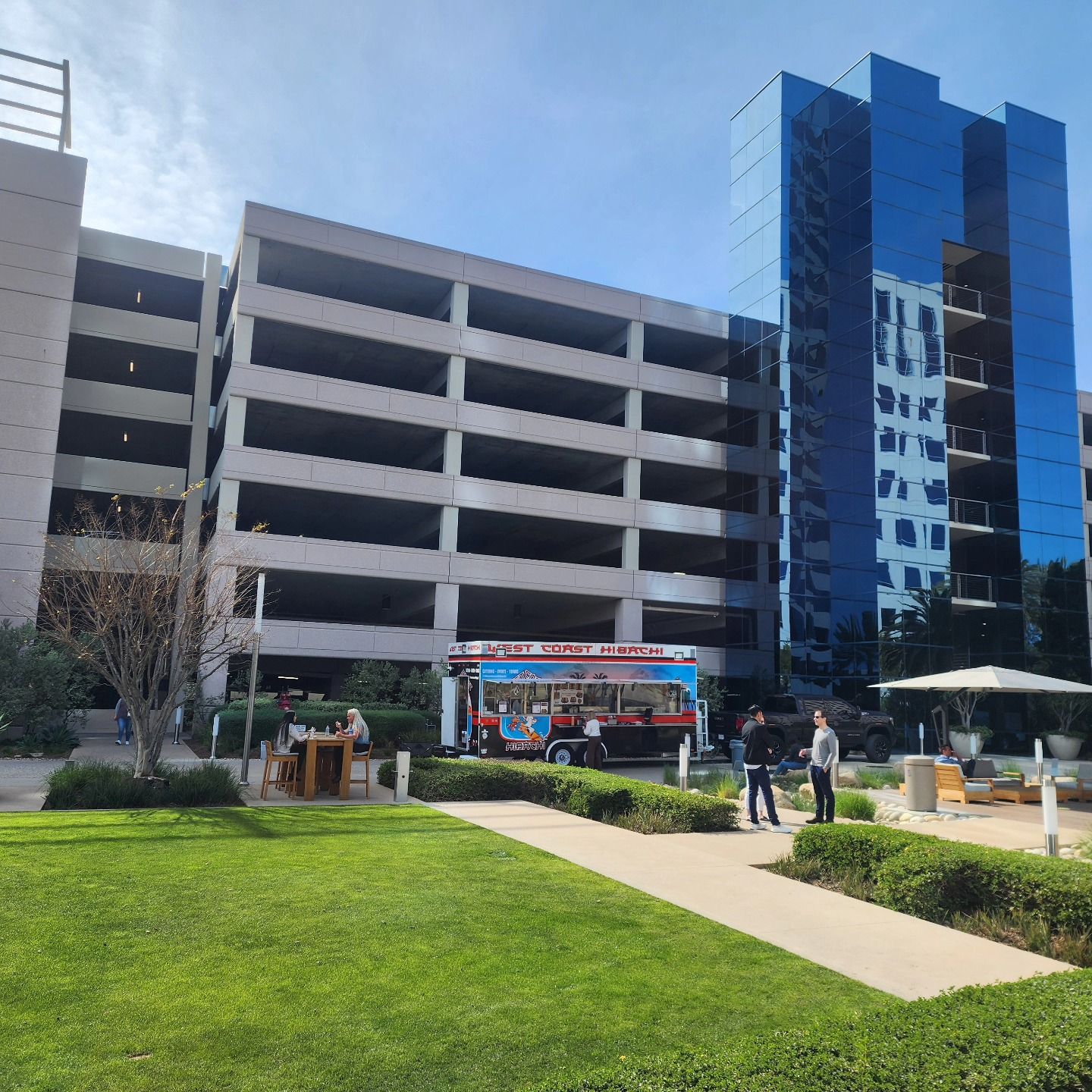 A parking garage with a food truck in front of it