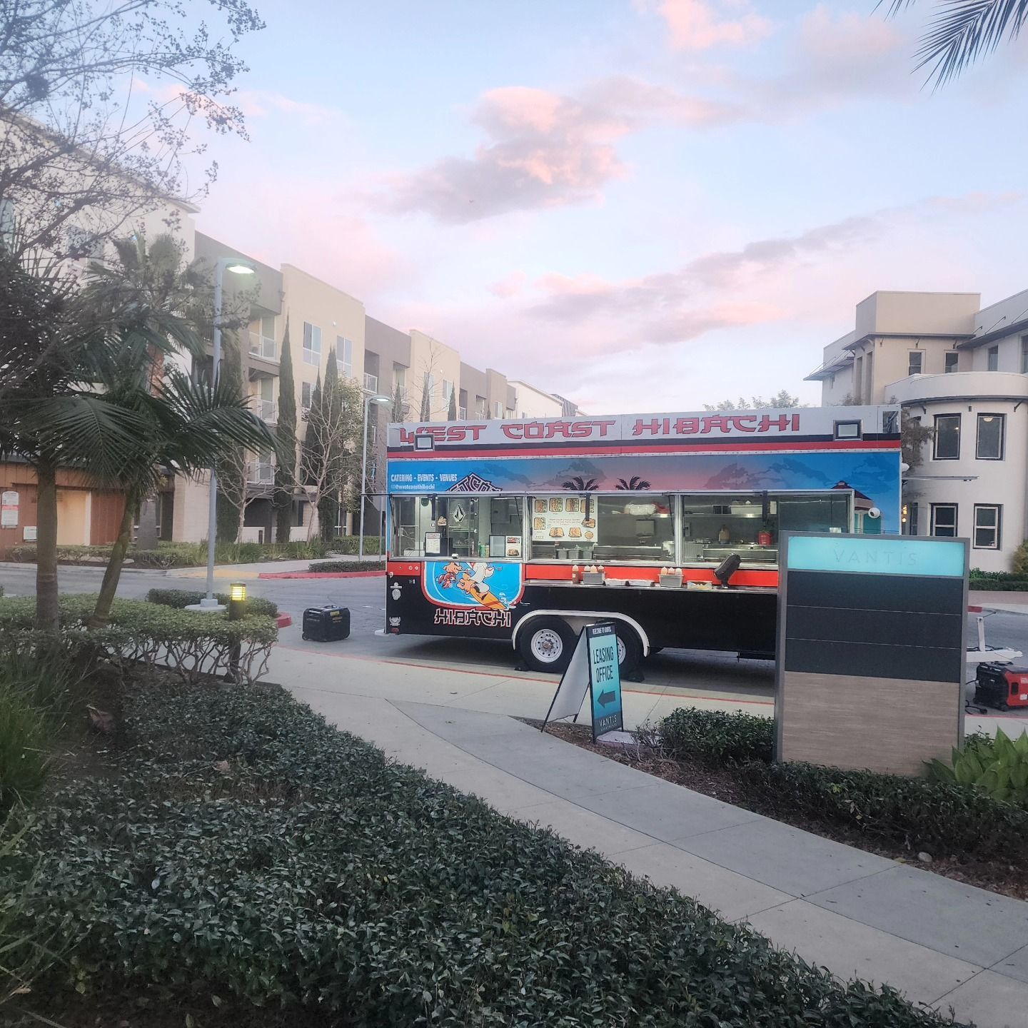 A food truck is parked on the side of the road