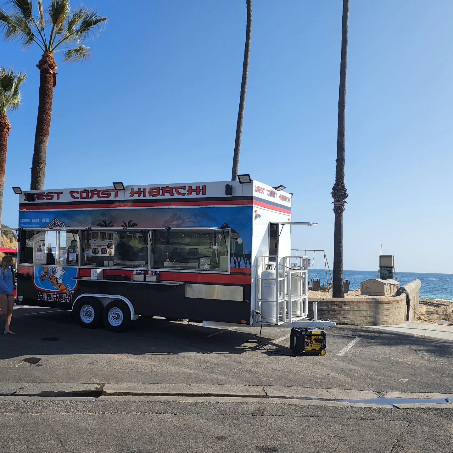 A coast hibachi food truck is parked on the side of the road