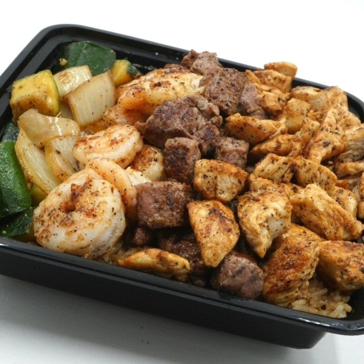 A black container filled with meat and shrimp