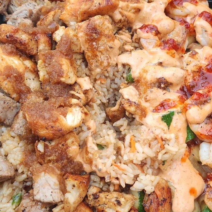 A close up of a plate of food with rice and meat