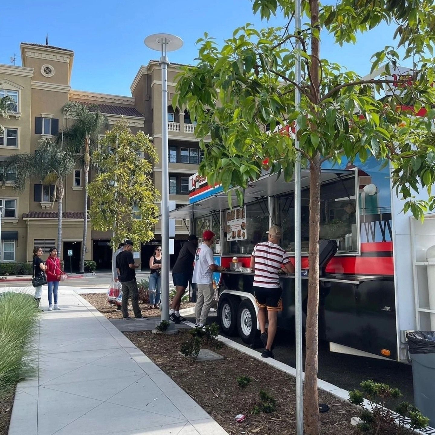 A food truck is parked in front of a building