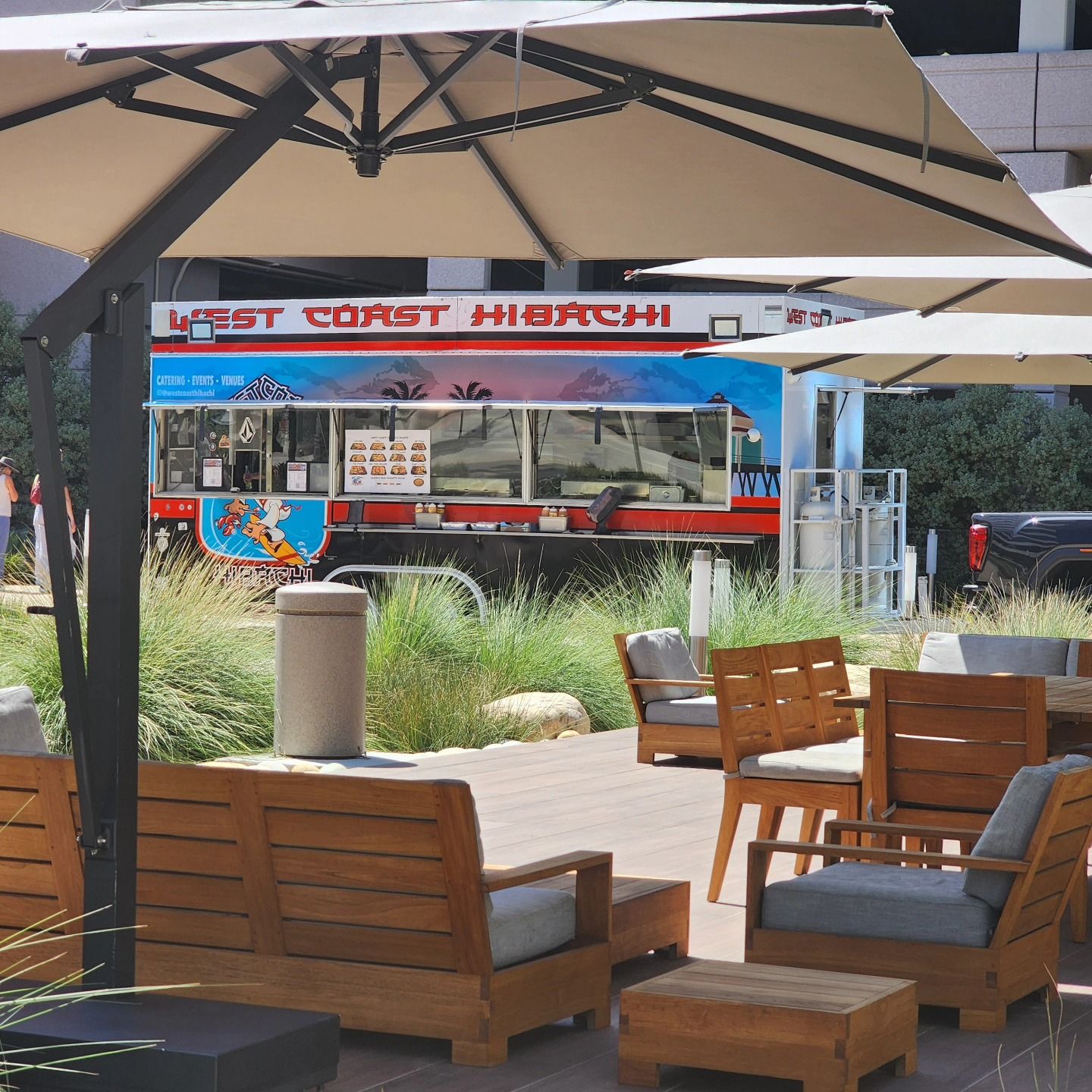 A west coast hibachi food truck is parked in a parking lot