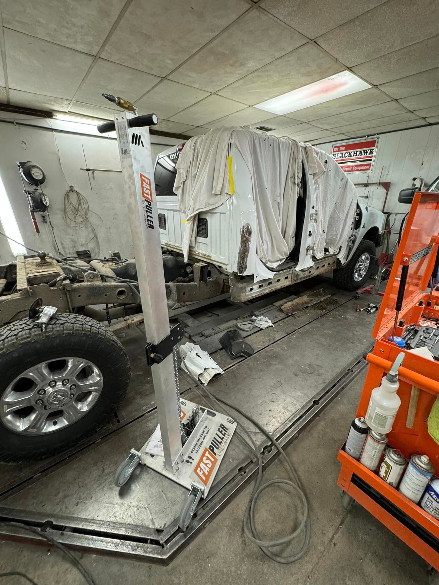 A truck is being worked on in a garage.