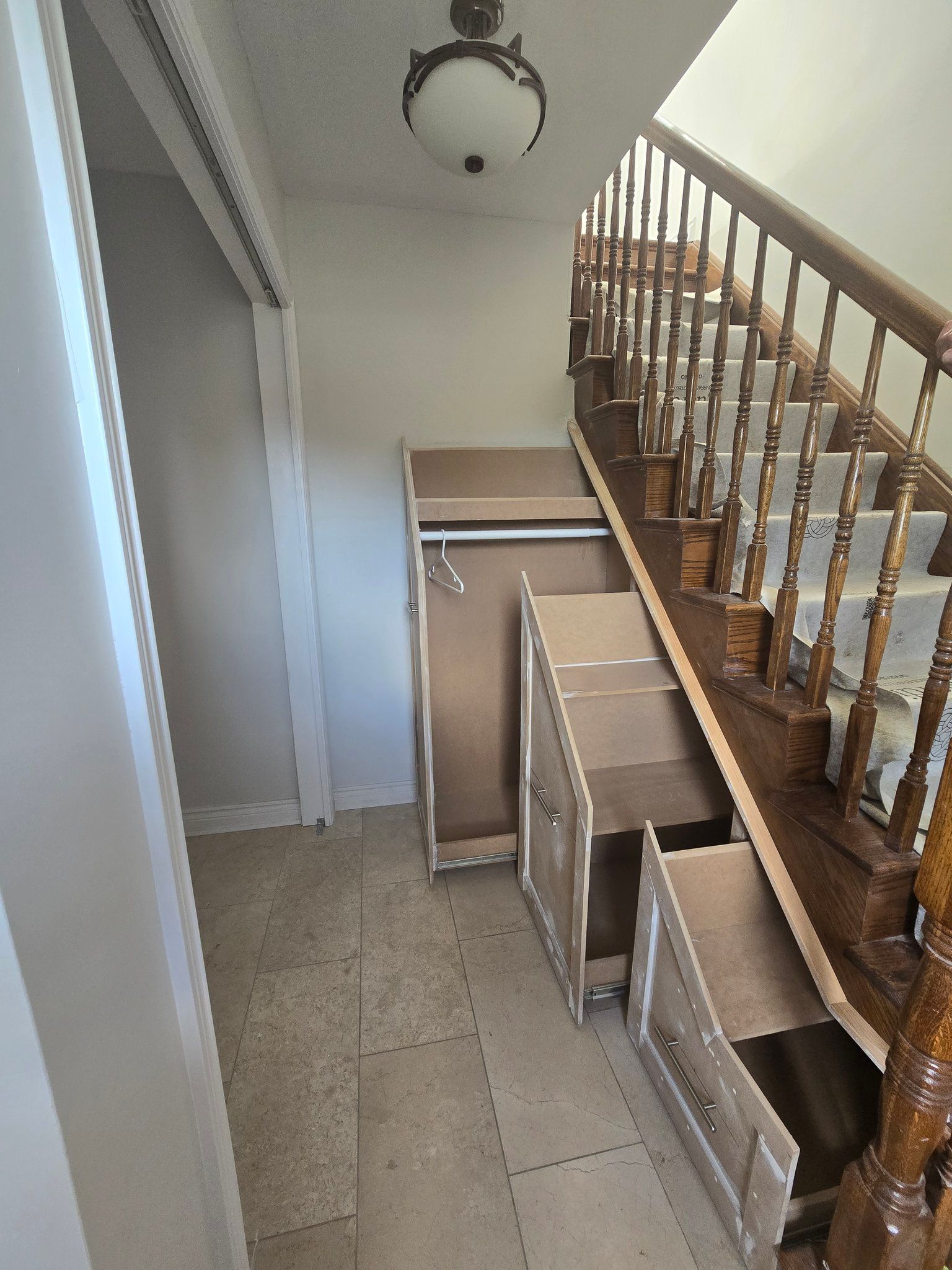 A wooden staircase with drawers underneath it