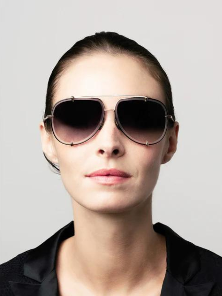 Woman wearing aviator sunglasses with gradient lenses.
