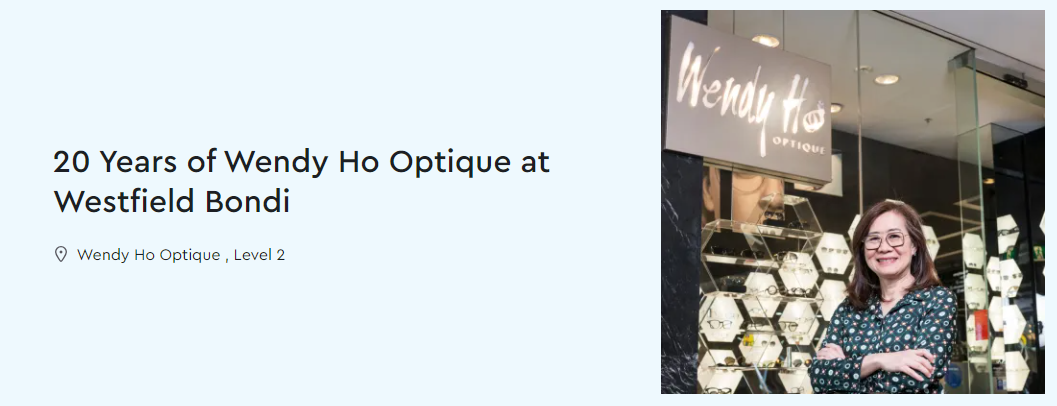 Woman in front of store with sign
