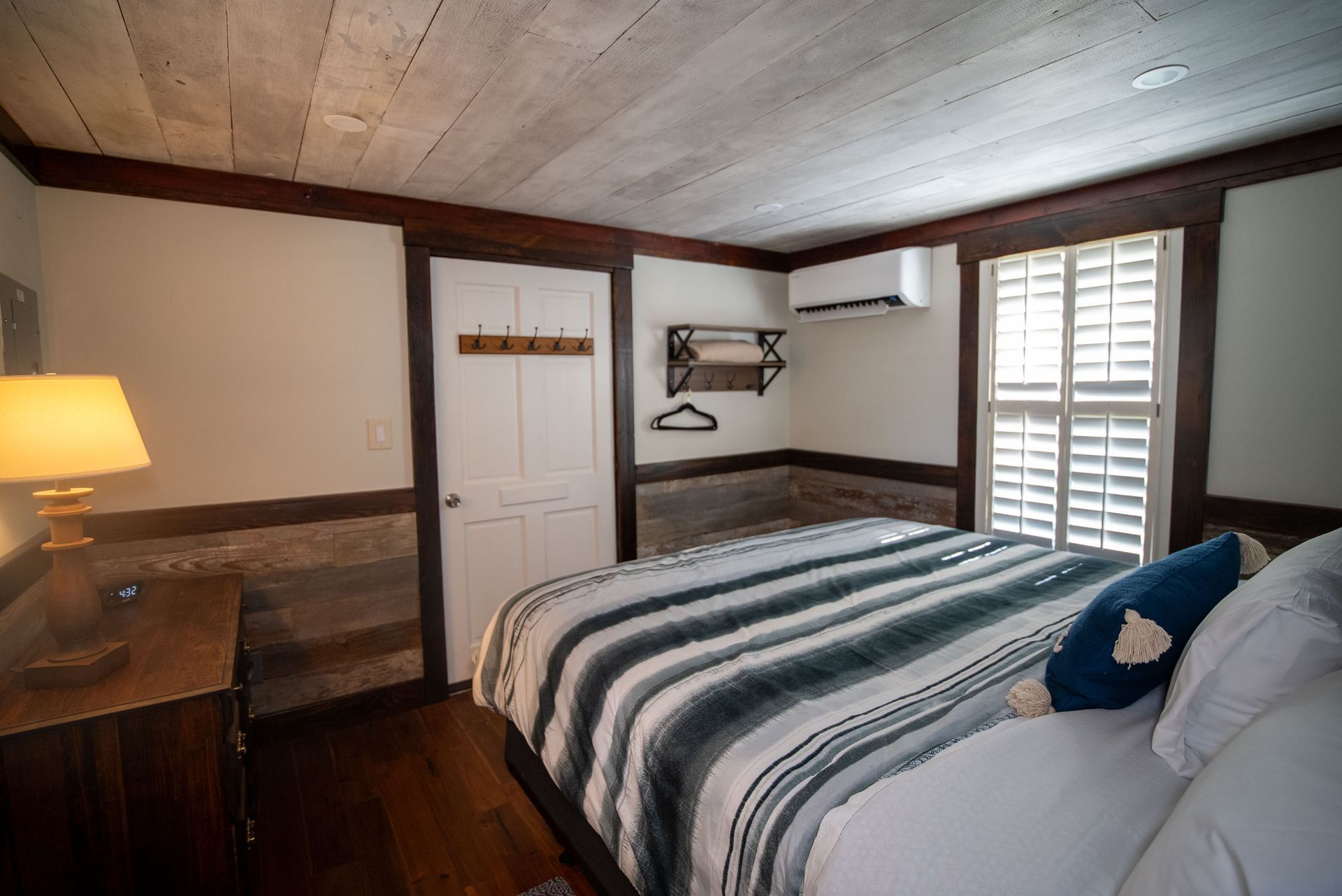 a bedroom with a king size bed and a window .