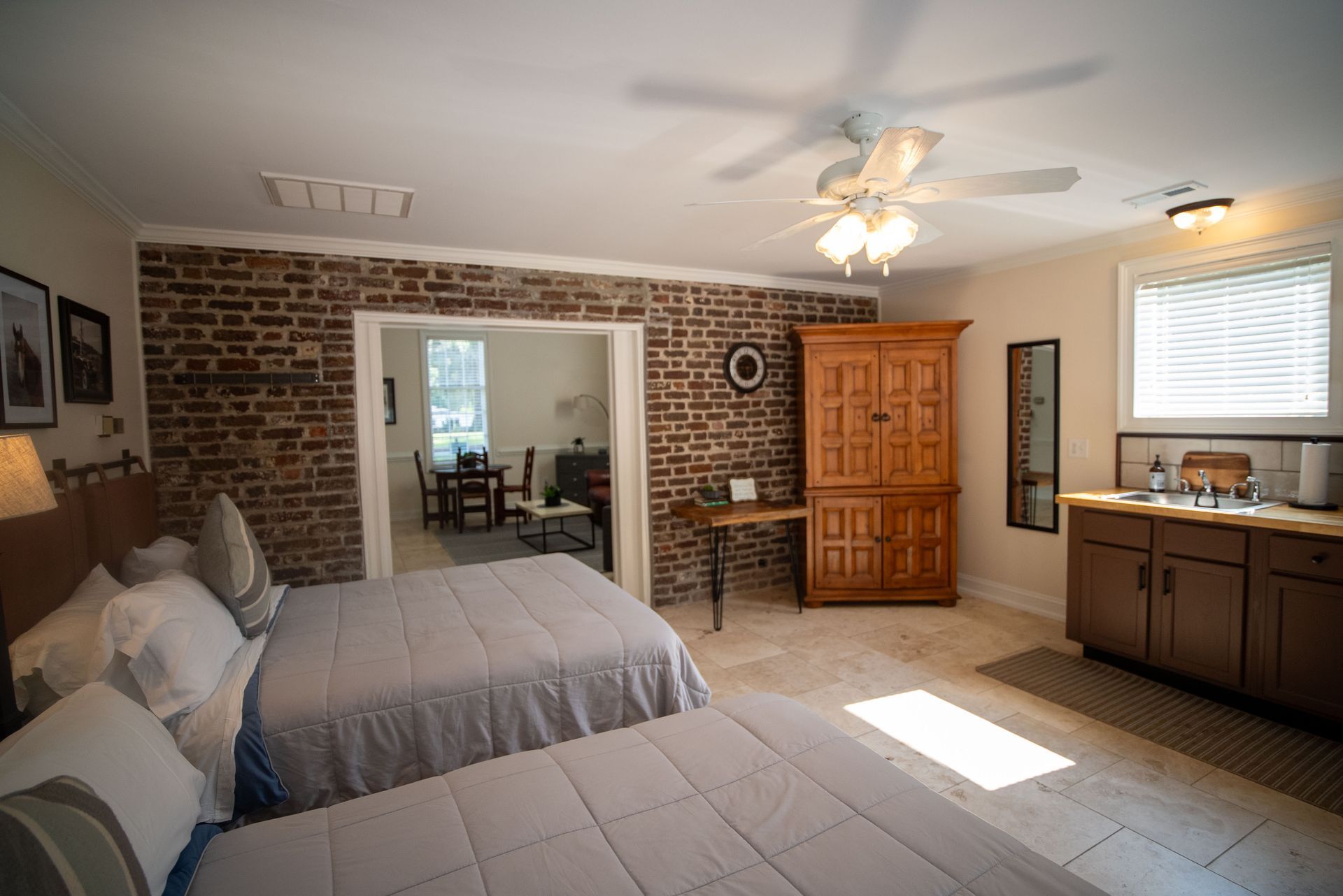a bedroom with two beds and a ceiling fan .