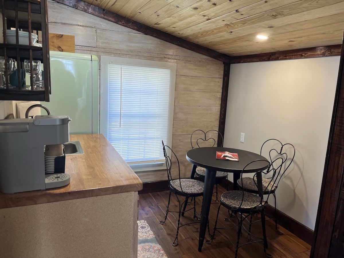a kitchen with a table and chairs and a coffee maker