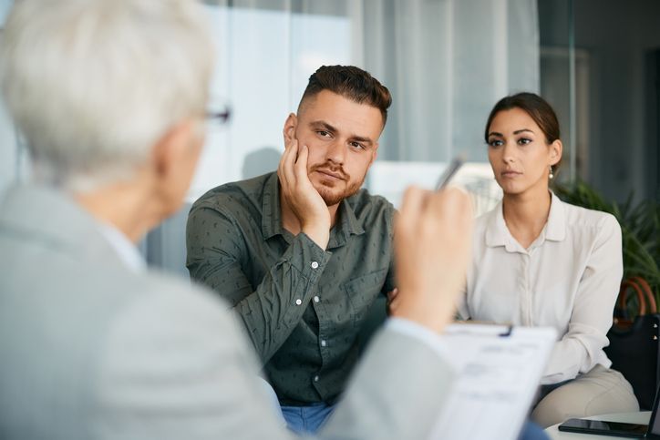 Young couple having marriage counseling with their therapist in the office