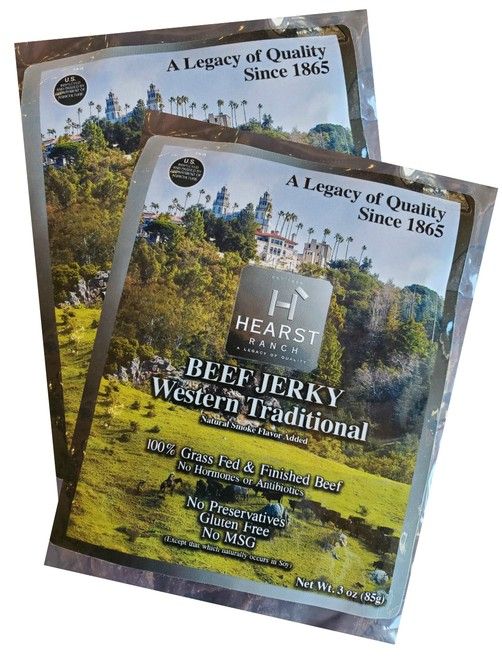 Two overlapping BeefJerky Western Tradition packages on a grassy outdoor scene