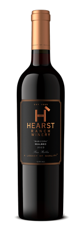 Bottle of Heartland rosé wine with a pale pink liquid and white cap on a white background