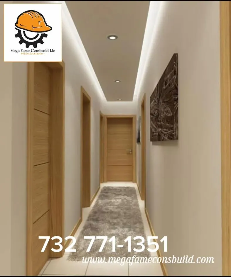 Modern hallway with light walls, wood doors, a gray runner rug, and recessed ceiling lighting, featuring a company logo.